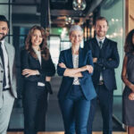 Multi-ethnic group of business persons standing side by side