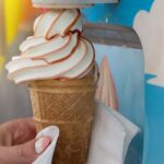An ice cream coming from an ice cream machine
